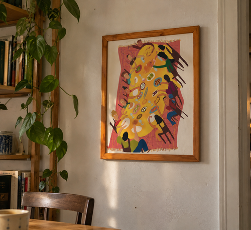 Feast Table framed art print in a honey wood frame on a wall